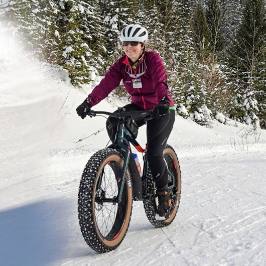 woman snowbiking in snow with fat tires
