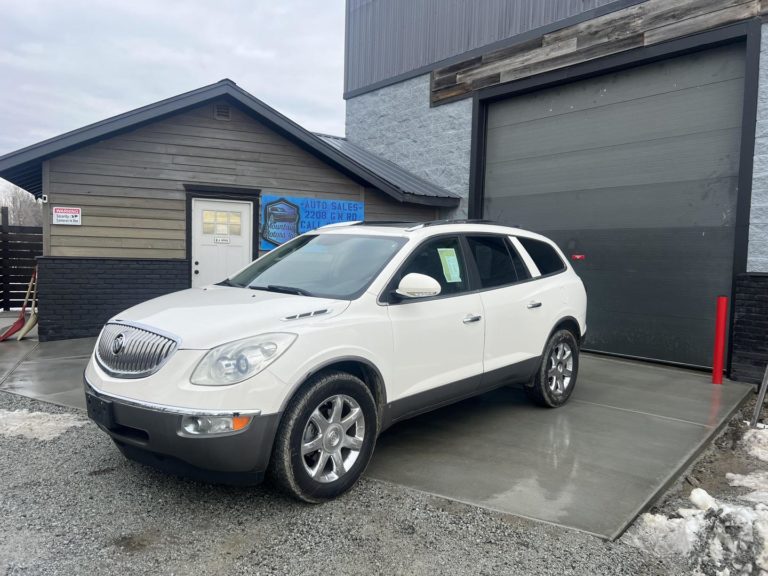 white SUV car for sale parked in front of Mountain Motors used car lot in Sandpoint