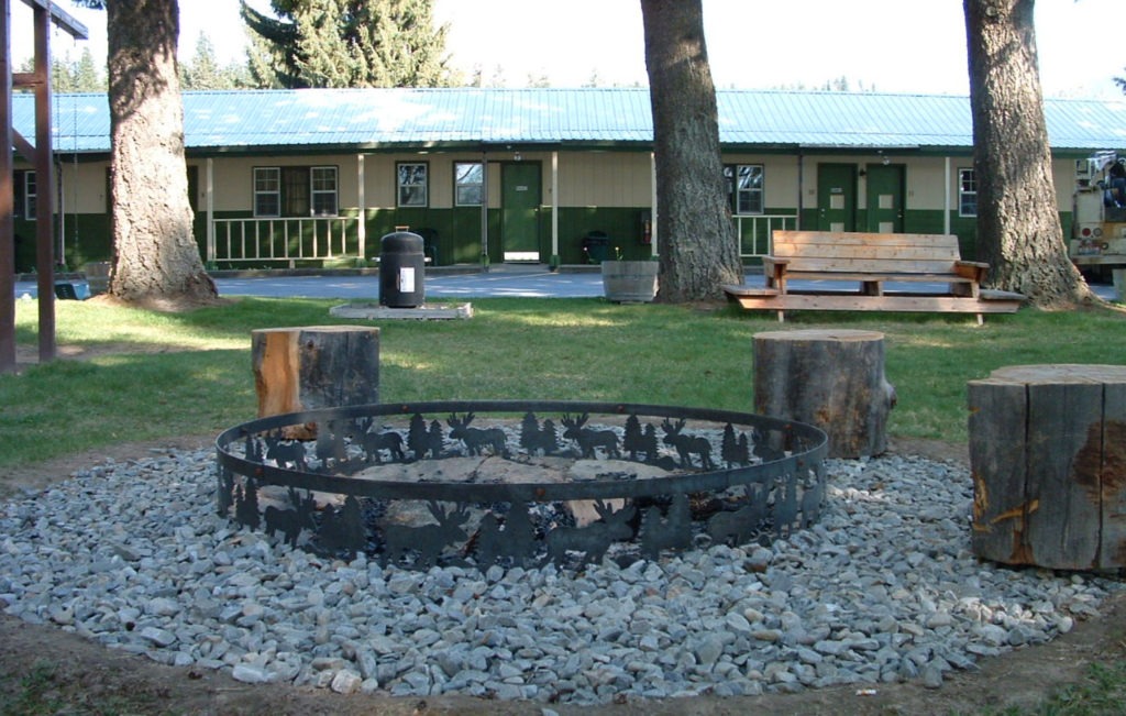 moose and trees rock firepit seating outside the Kootenai valley motel