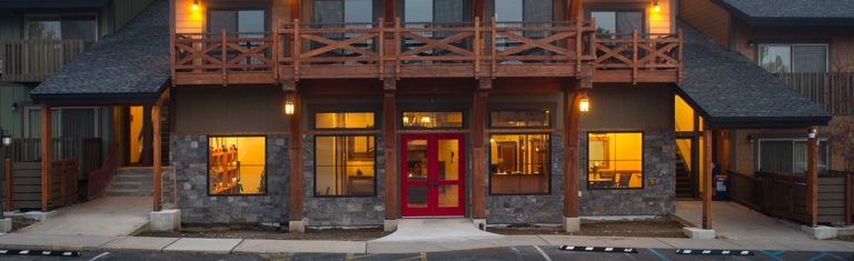 Stoneridge resort in Blanchard, Idaho red front doors wooden balconies timeshare lodging featuring 150 suites in four condominium buildings